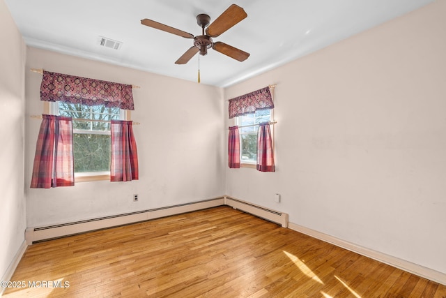 spare room with wood-type flooring, plenty of natural light, and ceiling fan