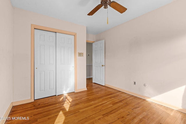 unfurnished bedroom with a closet, ceiling fan, and light wood-type flooring