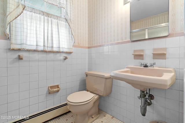 bathroom featuring a baseboard radiator, toilet, tile patterned flooring, and tile walls