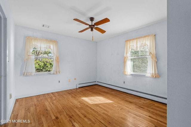 unfurnished room with ceiling fan, a baseboard radiator, and hardwood / wood-style floors