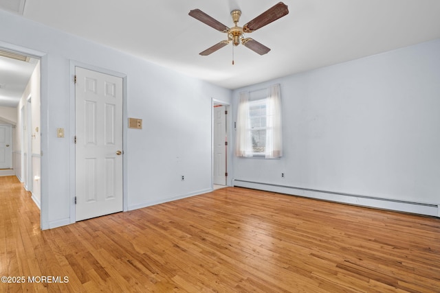 unfurnished room featuring ceiling fan, a baseboard heating unit, and light wood-type flooring