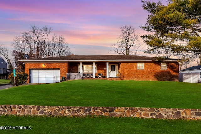 ranch-style home with a yard and a garage