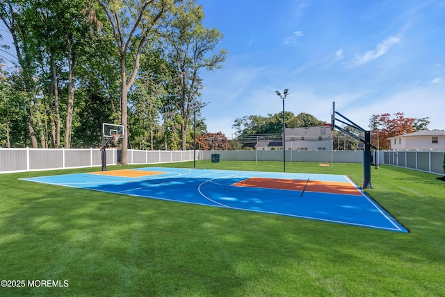 view of sport court with a yard