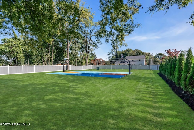 view of yard with basketball hoop