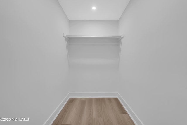 walk in closet with hardwood / wood-style floors