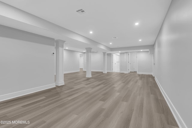 basement with light hardwood / wood-style flooring