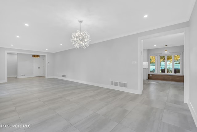 spare room with crown molding and an inviting chandelier