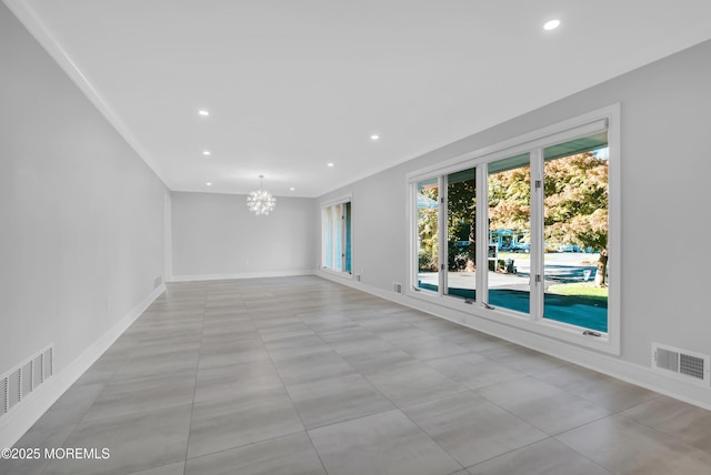 unfurnished room featuring a notable chandelier