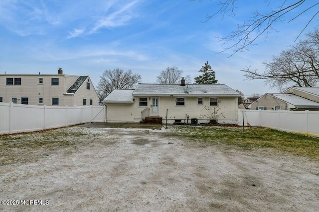 back of house with central AC unit