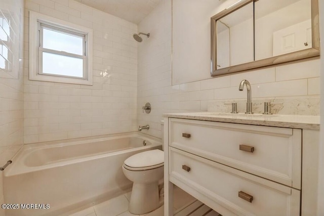 full bathroom with tile patterned floors, toilet, tile walls, vanity, and tiled shower / bath combo