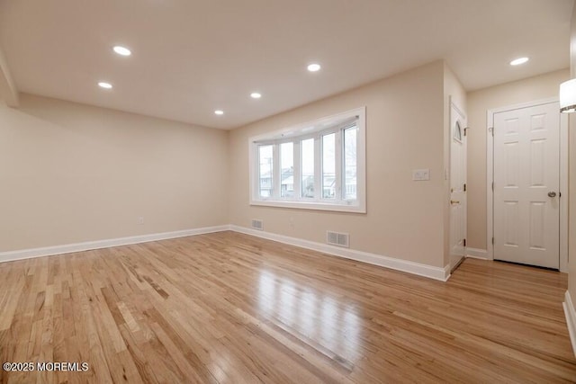 unfurnished room with light wood-type flooring