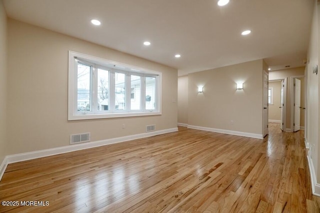 empty room with light hardwood / wood-style floors