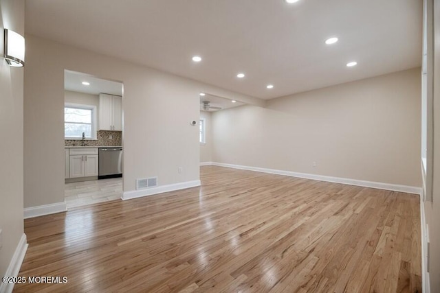 unfurnished room featuring ceiling fan and light hardwood / wood-style floors