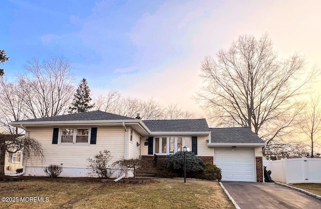 view of front of house with a garage and a lawn