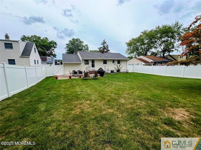 rear view of property featuring a patio and a yard