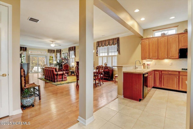 kitchen featuring black appliances, sink, backsplash, kitchen peninsula, and plenty of natural light