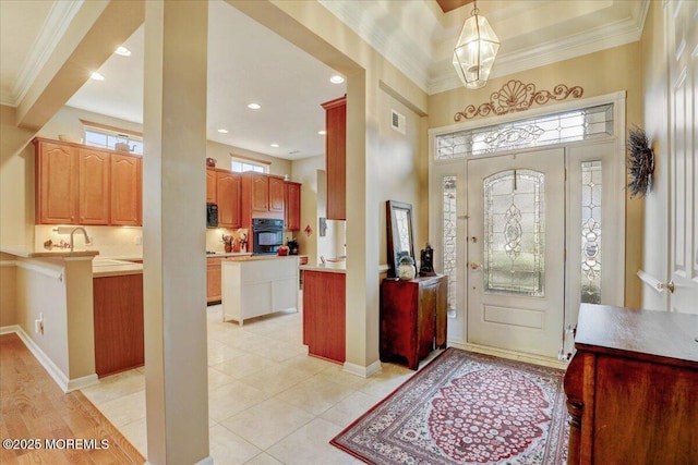 tiled foyer entrance featuring ornamental molding