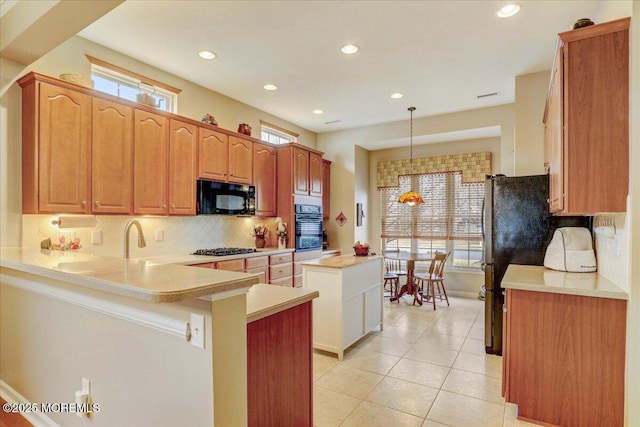 kitchen featuring light tile patterned floors, black appliances, decorative backsplash, decorative light fixtures, and kitchen peninsula