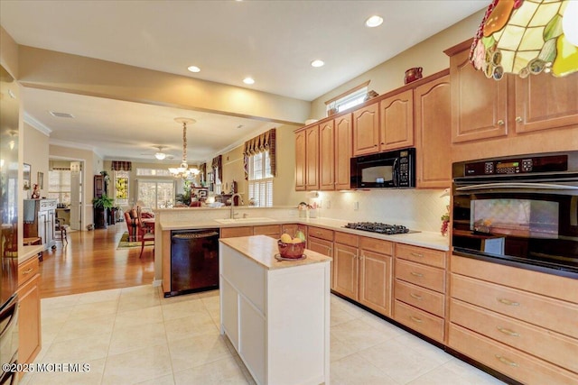 kitchen featuring black appliances, sink, decorative backsplash, ornamental molding, and kitchen peninsula