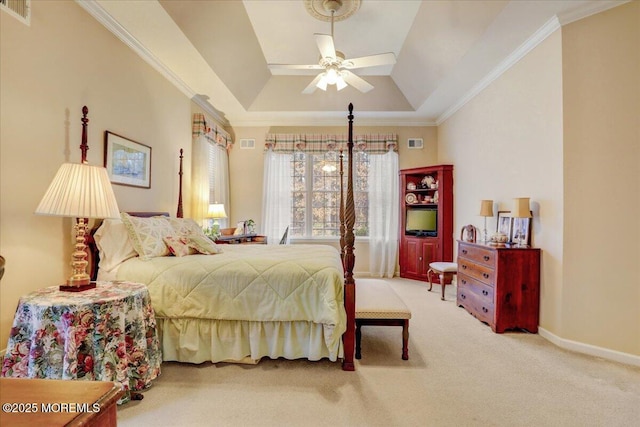 bedroom featuring ornamental molding, a tray ceiling, and carpet