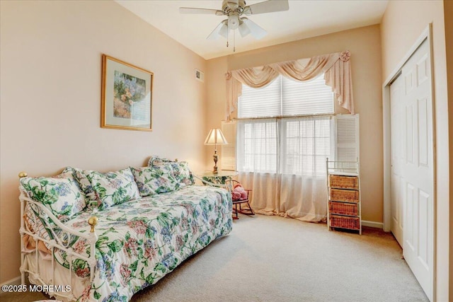 carpeted bedroom with a closet and ceiling fan