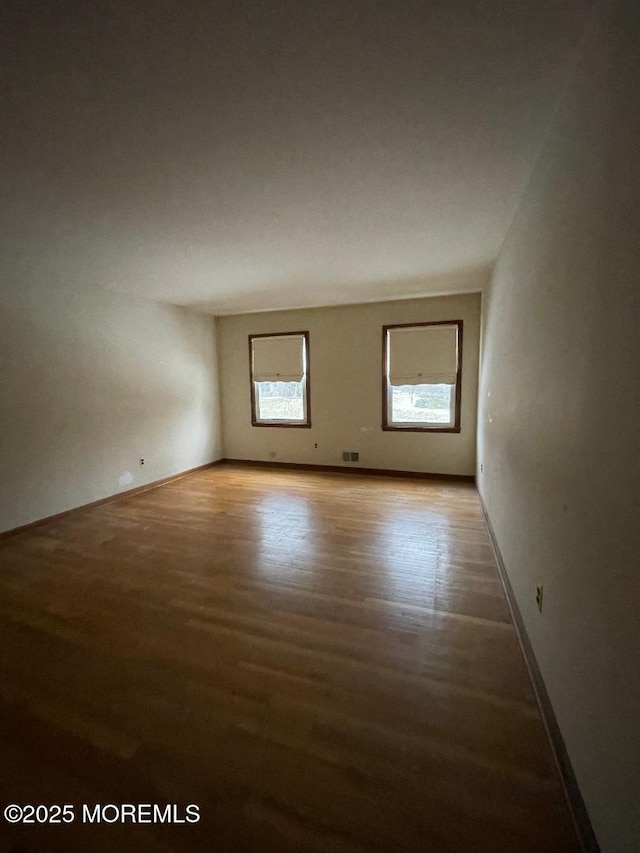 spare room with hardwood / wood-style flooring