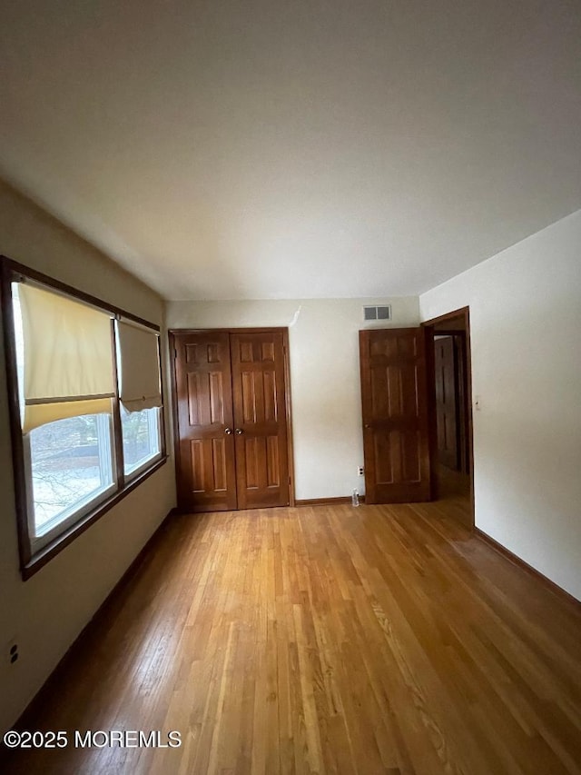 unfurnished bedroom with light hardwood / wood-style floors