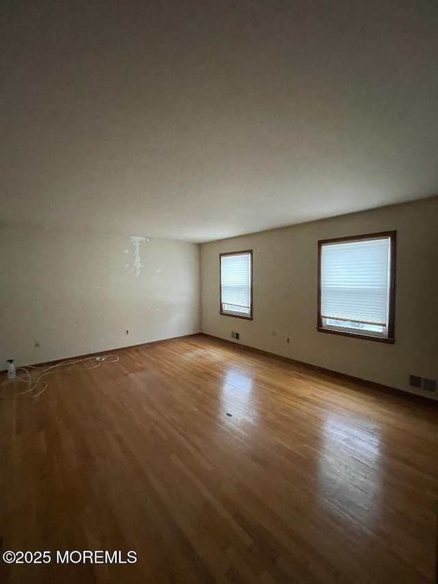 spare room with light hardwood / wood-style flooring