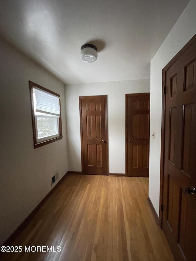 unfurnished bedroom with light wood-type flooring