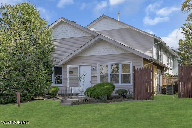 view of front of house featuring central AC and a front yard