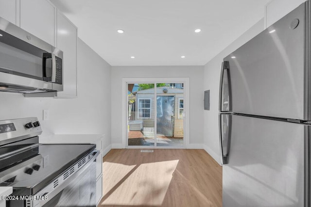 100 Governors Rd Unit 1000, Lakewood, NJ 08701 - kitchen featuring light hardwood / wood-style flooring, white cabinets, and appliances with stainless steel finishes