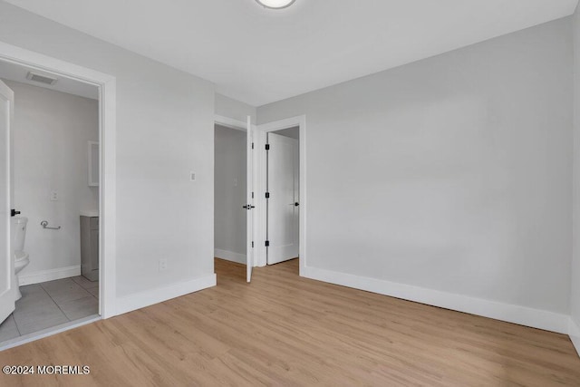 100 Governors Rd Unit 1000, Lakewood, NJ 08701 - unfurnished bedroom with ensuite bath and light hardwood / wood-style floors