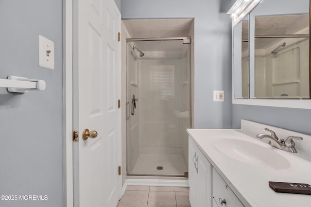 bathroom with vanity, a shower with shower door, and tile patterned flooring