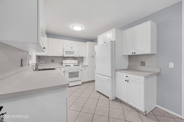 kitchen featuring white cabinetry, sink, light tile patterned floors, and white appliances