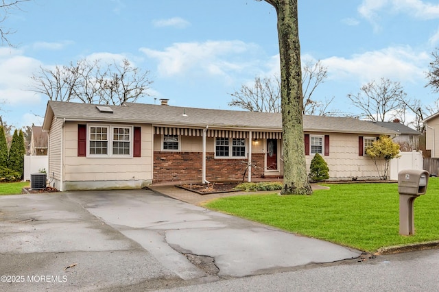 single story home with central AC and a front yard