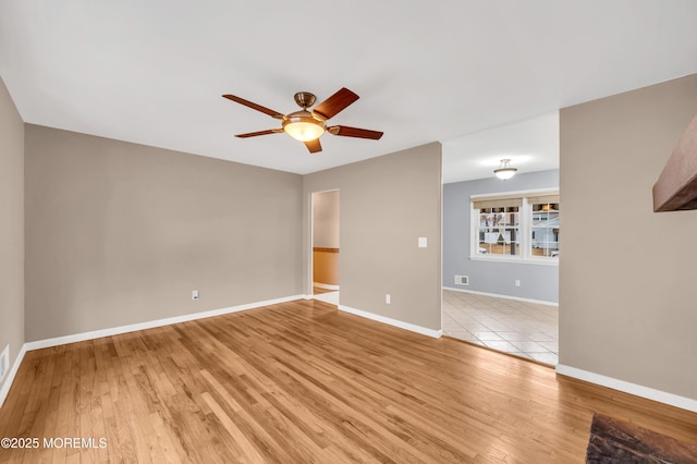 spare room featuring ceiling fan and light hardwood / wood-style floors