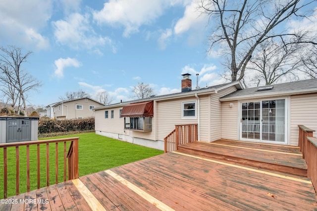 wooden deck featuring a shed and a yard