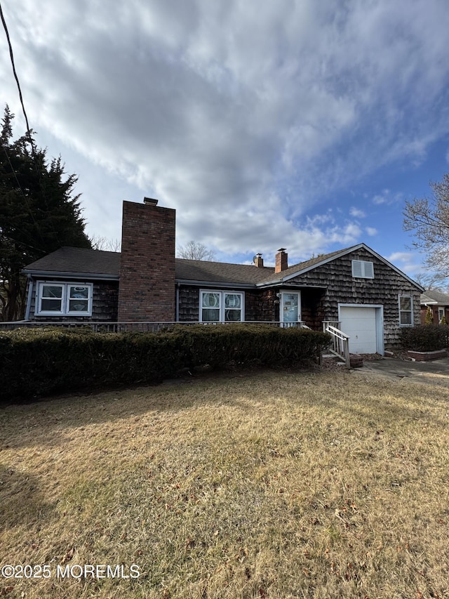 ranch-style home with a garage and a front lawn