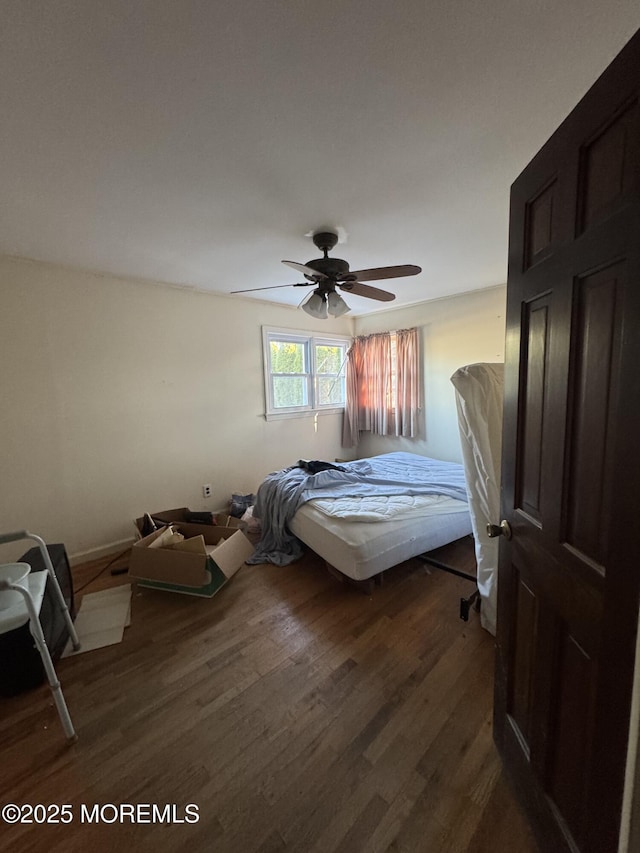 bedroom featuring ceiling fan and dark hardwood / wood-style flooring