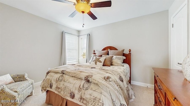 bedroom with light carpet, a ceiling fan, and baseboards