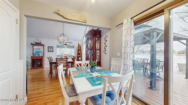 dining space featuring light wood-style floors and a notable chandelier