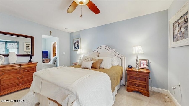 bedroom featuring light carpet, ceiling fan, and baseboards