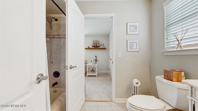 full bath featuring tile patterned flooring, bathtub / shower combination, toilet, and baseboards