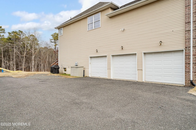 view of side of home featuring a garage