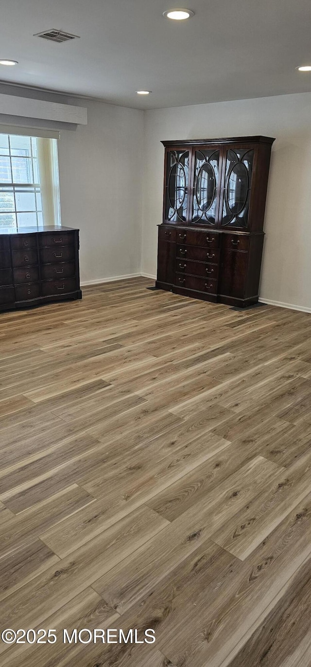 spare room with hardwood / wood-style floors