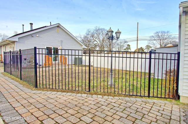 view of gate with a yard