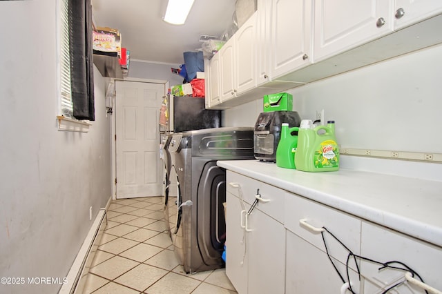 laundry room featuring washing machine and clothes dryer, light tile patterned floors, a baseboard radiator, and cabinets