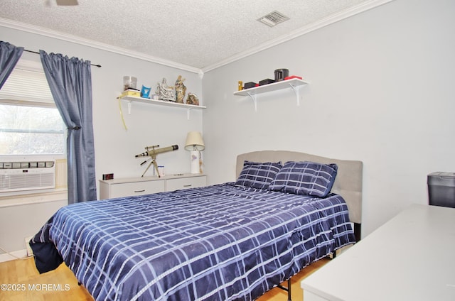 bedroom with a textured ceiling, cooling unit, crown molding, and wood-type flooring