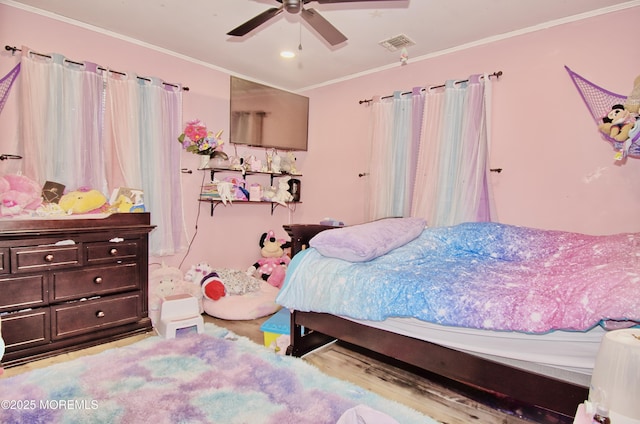 bedroom with ceiling fan and ornamental molding