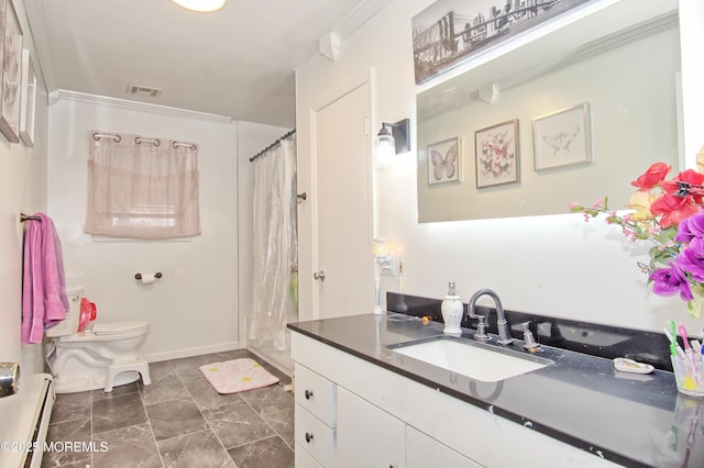 bathroom with a baseboard heating unit, toilet, vanity, and crown molding